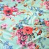 Tesatura tip shantung din matase naturala - motive florale și fluturi multicolor pe fond verde deschis